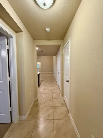 a view of a kitchen with a sink and a refrigerator