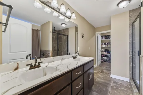 a bathroom with a double vanity sink and a mirror