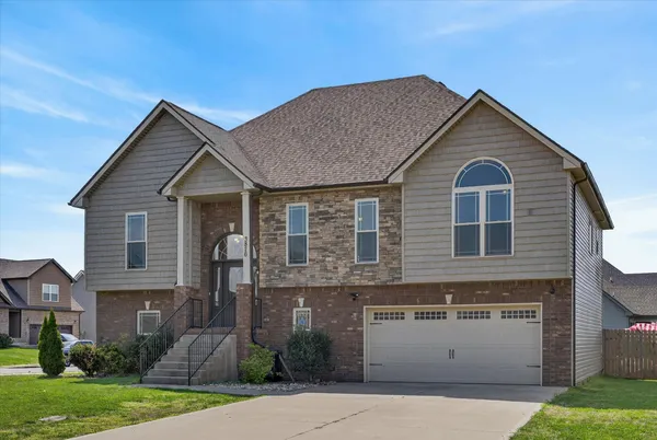 a front view of a house with a yard and garage