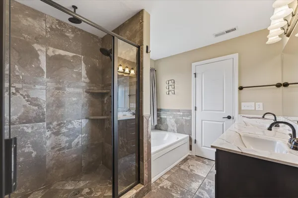 a bathroom with a shower and a sink