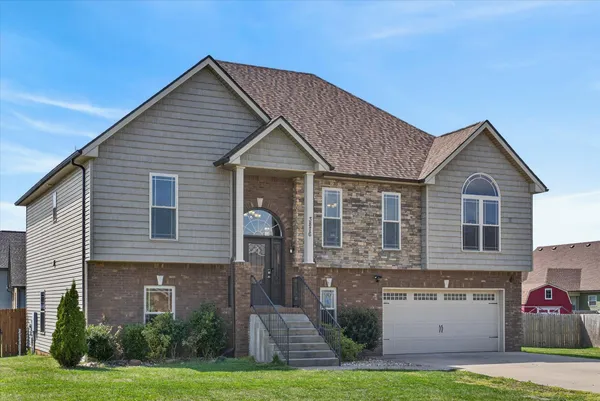 a front view of a house with a yard and garage