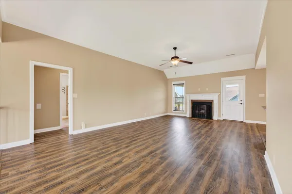 wooden floor in an empty room with a fireplace