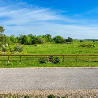 a view of a house with backyard and a lake view