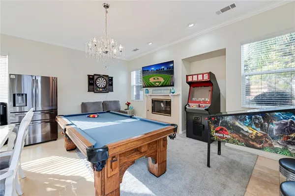 a room with furniture a flat screen tv and a chandelier