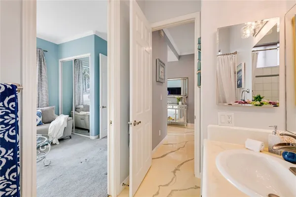 a bathroom with a tub sink and mirror