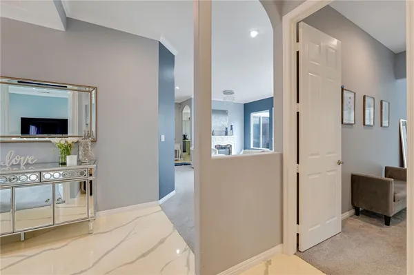 a bathroom with a tub sink and mirror
