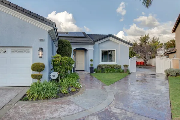 a front view of a house with garden