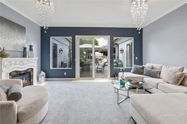 a living room with furniture and a chandelier