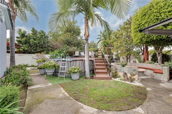 a backyard of a house with table and chairs