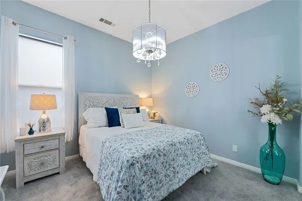 a bedroom with a bed and a lamp