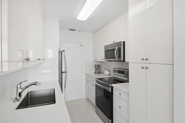 a kitchen with a refrigerator sink and stove