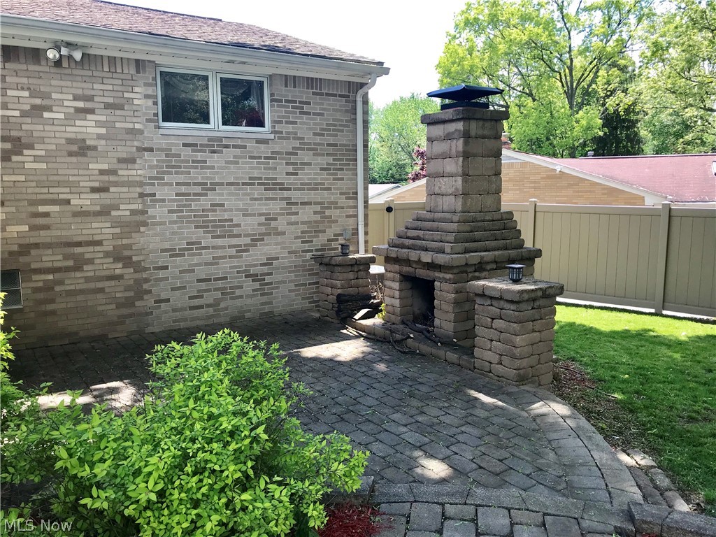 4895 4th Street Northwest Canton, OH 44708 - Photo 11 of 31 Off the porch/sunroom is this beautiful outdoor spot with very cool fireplace, and outdoor speaker hookups.