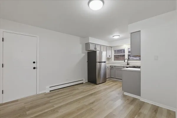 a kitchen with a refrigerator and a stove top oven