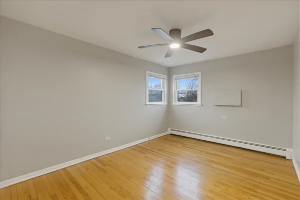 a view of empty room with wooden floor