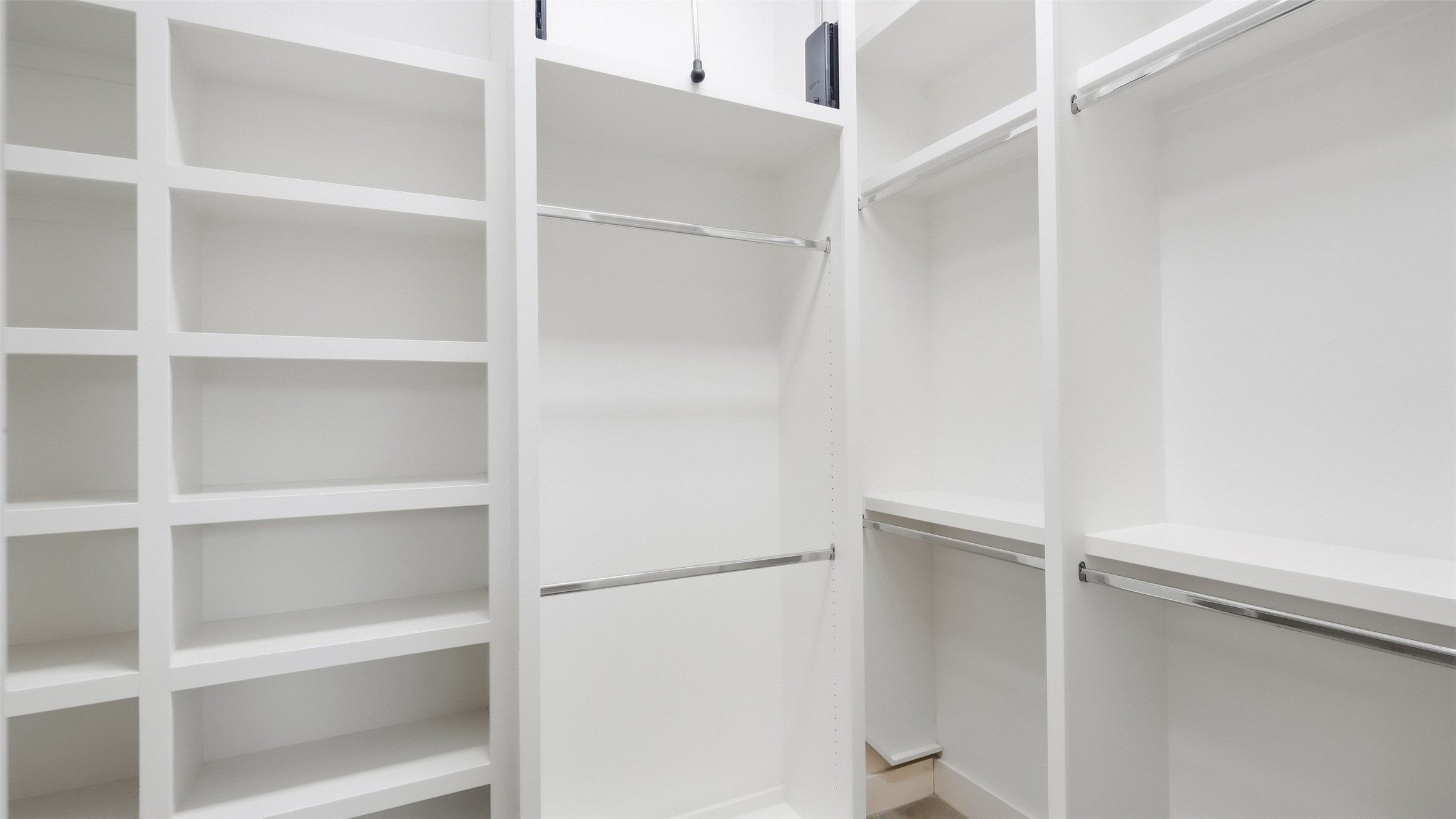 5910 Hudson Bend Road Austin, TX 78734 - Photo 29 of 40 Custom built-in shelving and hanging rods maximize storage in this spacious walk-in closet.