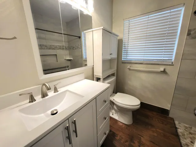 a bathroom with a sink toilet and shower