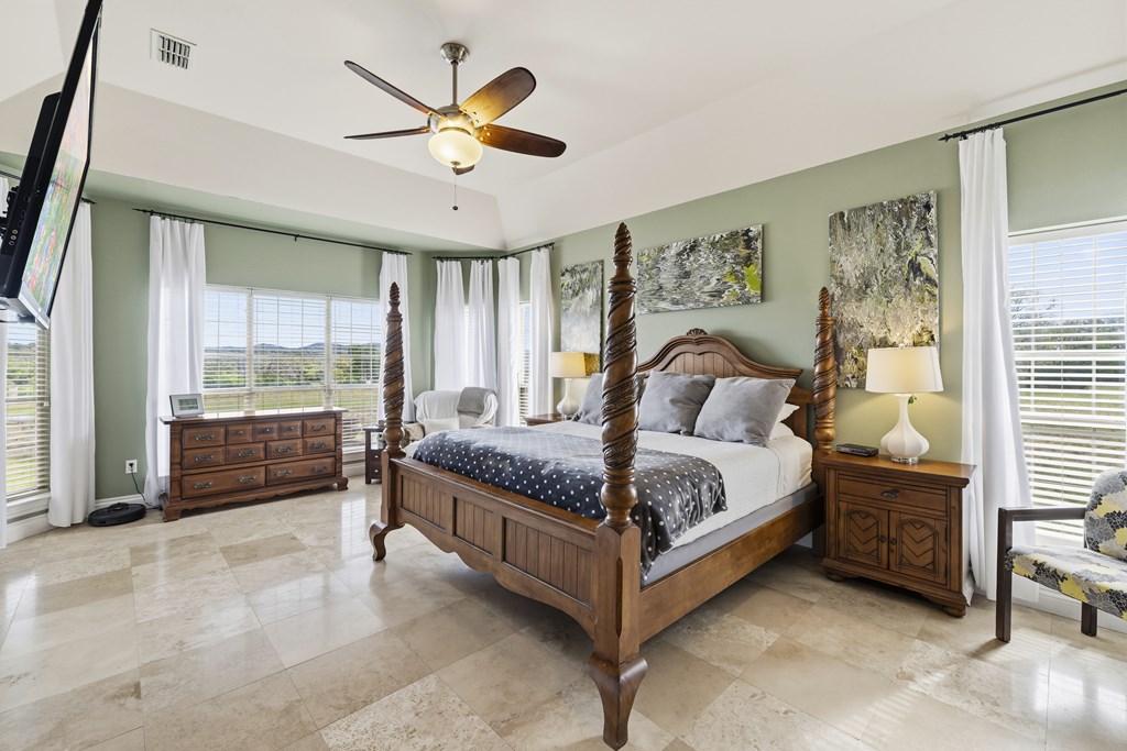 360 Bluff Creek Road North Center Point, TX 78010 - Photo 12 of 64 a bedroom with a bed a window and a chandelier