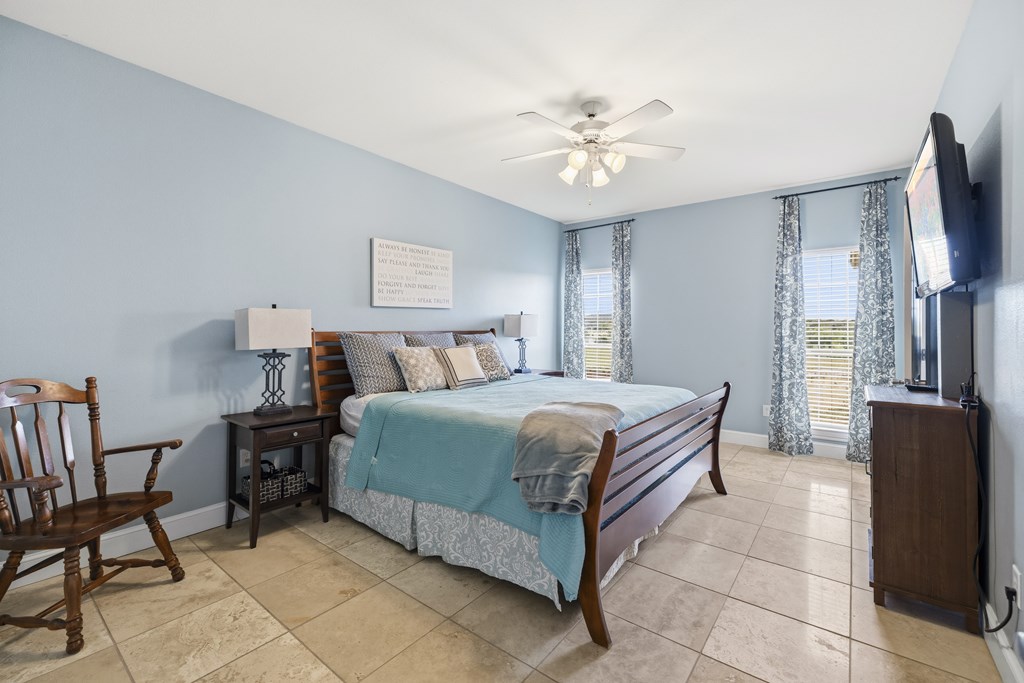 360 Bluff Creek Road North Center Point, TX 78010 - Photo 22 of 64 a bedroom with a bed and a chandelier