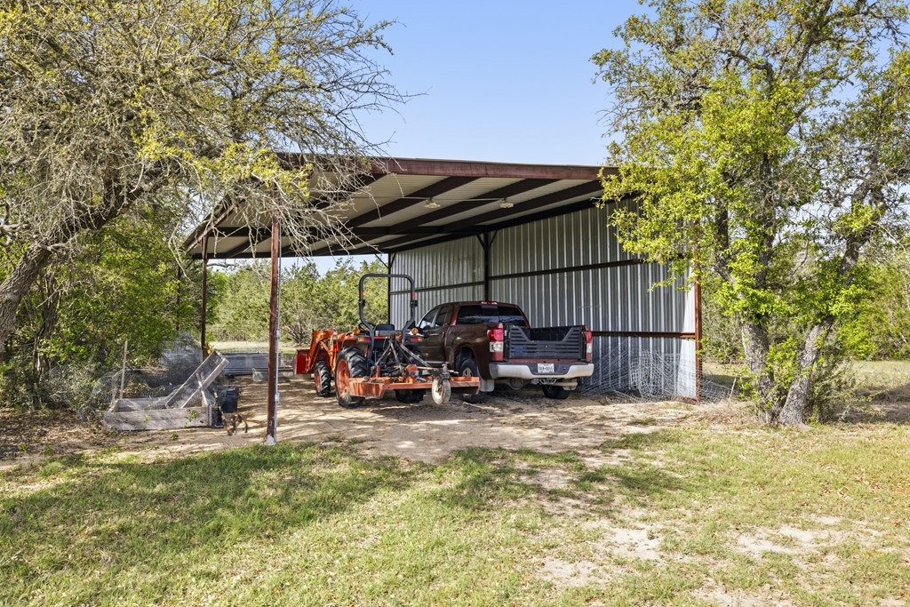 360 Bluff Creek Road North Center Point, TX 78010 - Photo 39 of 64 a view of a chairs and table in the back yard of the house