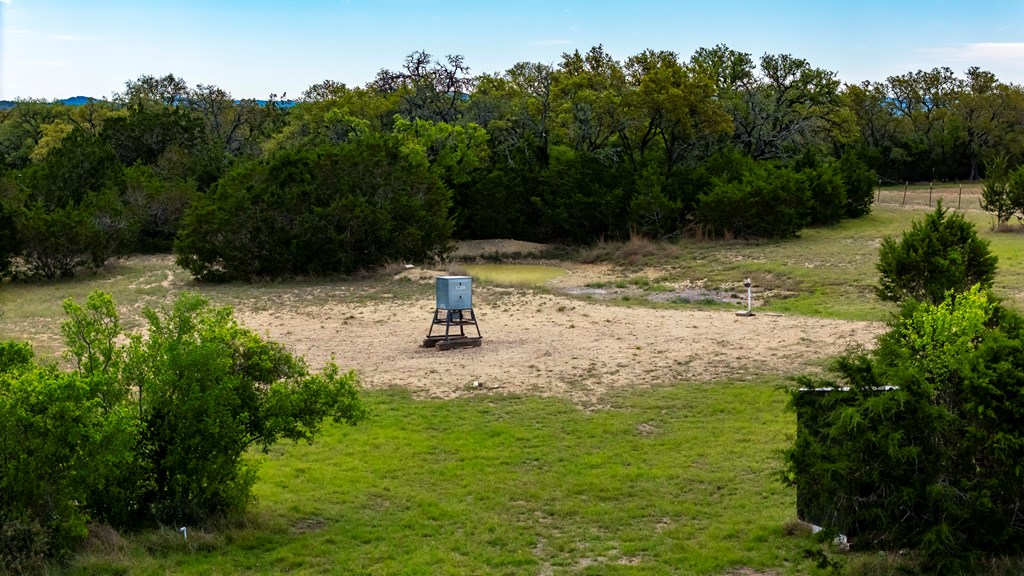 360 Bluff Creek Road North Center Point, TX 78010 - Photo 56 of 64 a view of a water fountain with a tree in the background