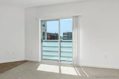 a view of an empty room with a kitchen
