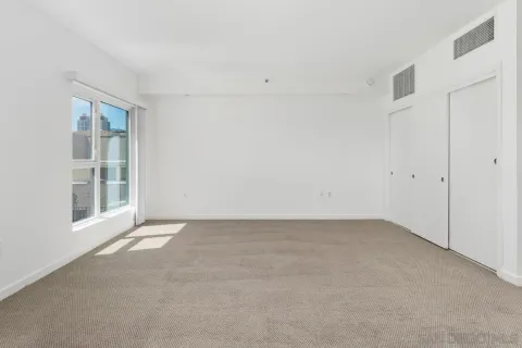 a view of a livingroom with furniture and a kitchen