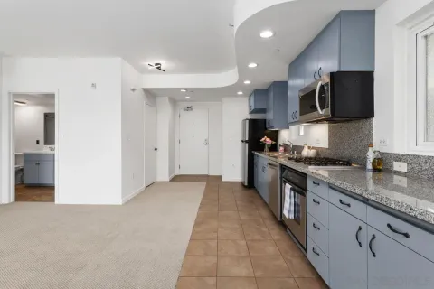 a kitchen with stainless steel appliances granite countertop a refrigerator and a sink