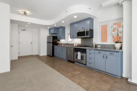 a kitchen with granite countertop a sink and stainless steel appliances
