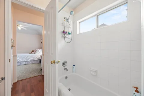a bathroom with a bathtub and shower