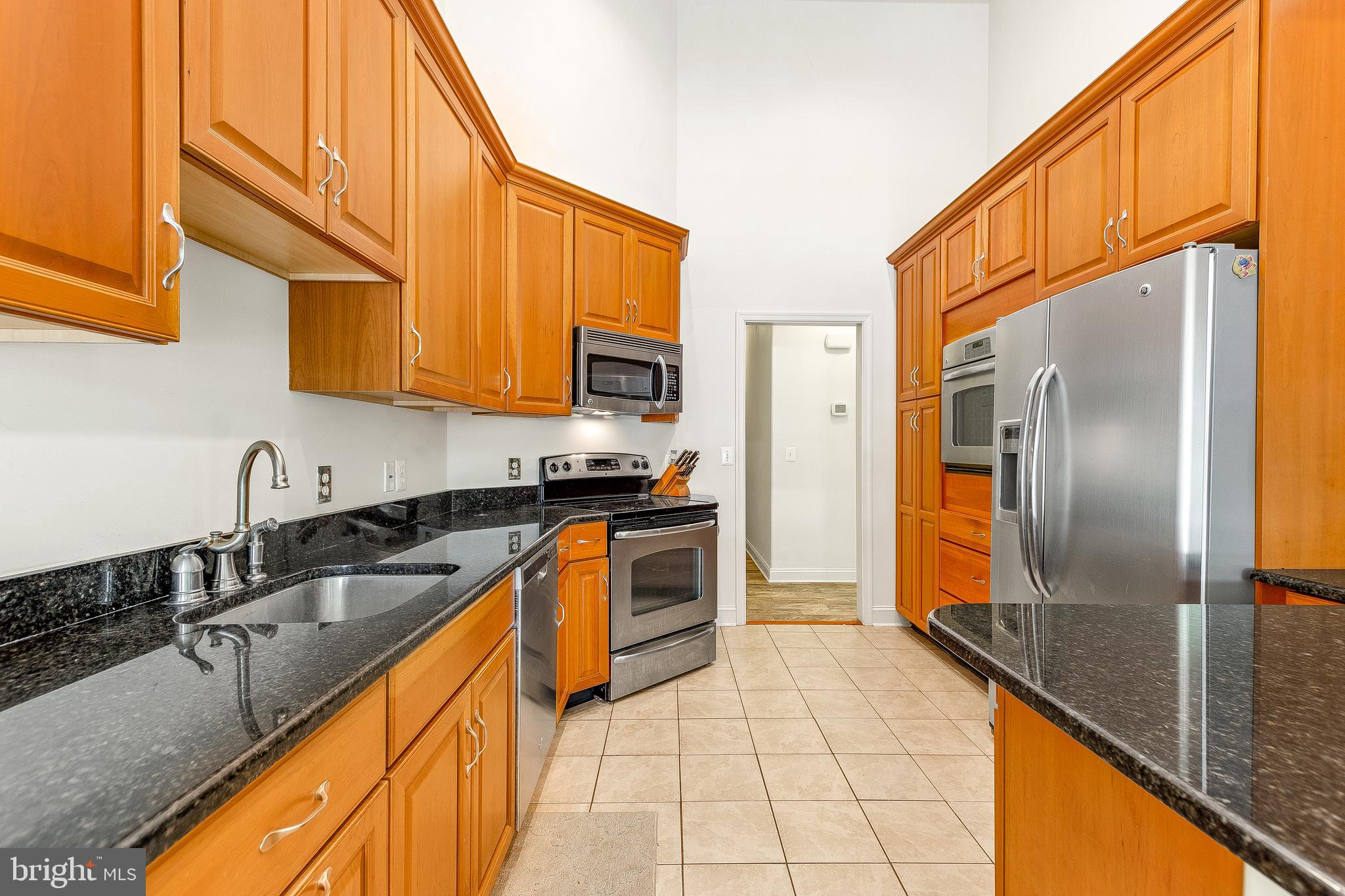 1808 Wilson Road Huntingtown, MD 20639 - Photo 18 of 53 a kitchen with stainless steel appliances granite countertop a sink a stove and a refrigerator