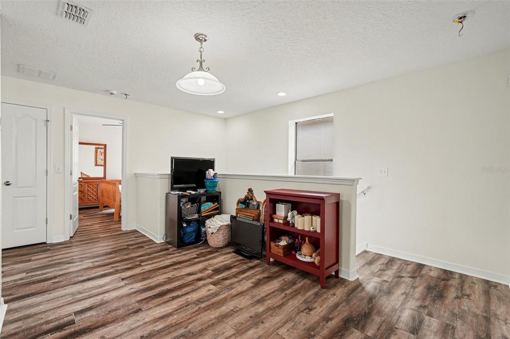 1606 Acadia Harbor Place Brandon, FL 33511 - Photo 20 of 38 a view of a livingroom with wooden floor and a fireplace