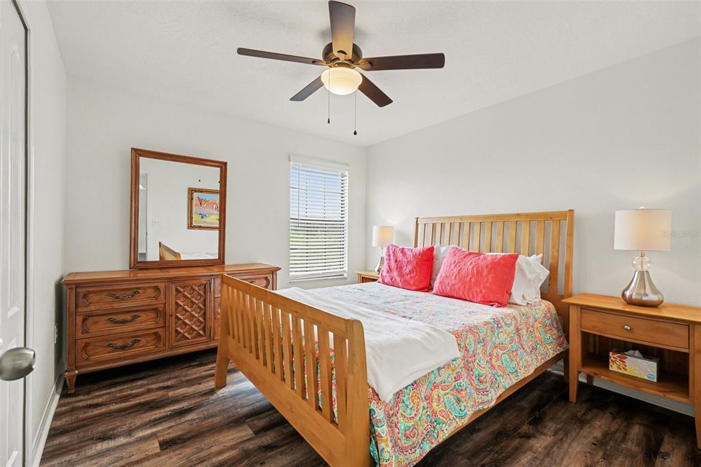 1606 Acadia Harbor Place Brandon, FL 33511 - Photo 21 of 38 a bedroom with bed and a chandelier