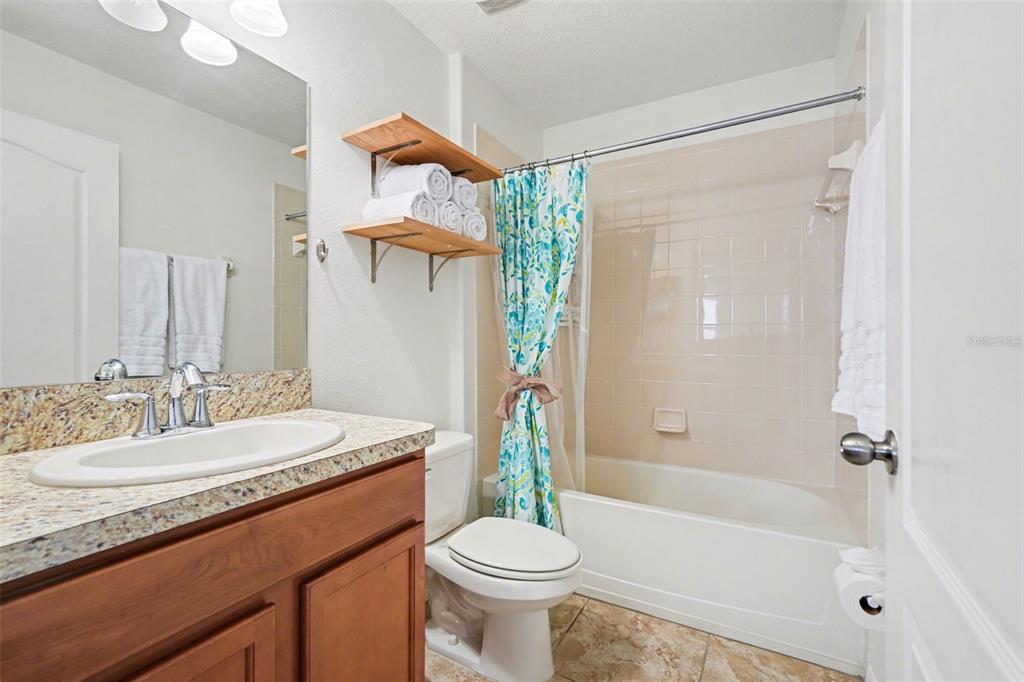 1606 Acadia Harbor Place Brandon, FL 33511 - Photo 22 of 38 a bathroom with a sink a toilet and shower