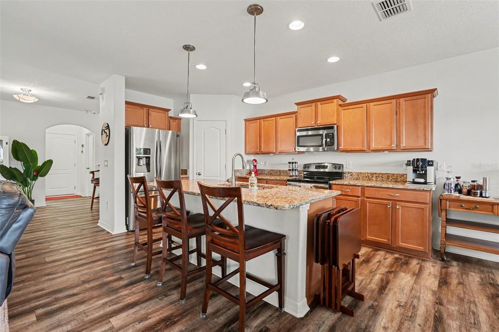 1606 Acadia Harbor Place Brandon, FL 33511 - Photo 5 of 38 a kitchen with stainless steel appliances granite countertop a stove a sink and a refrigerator