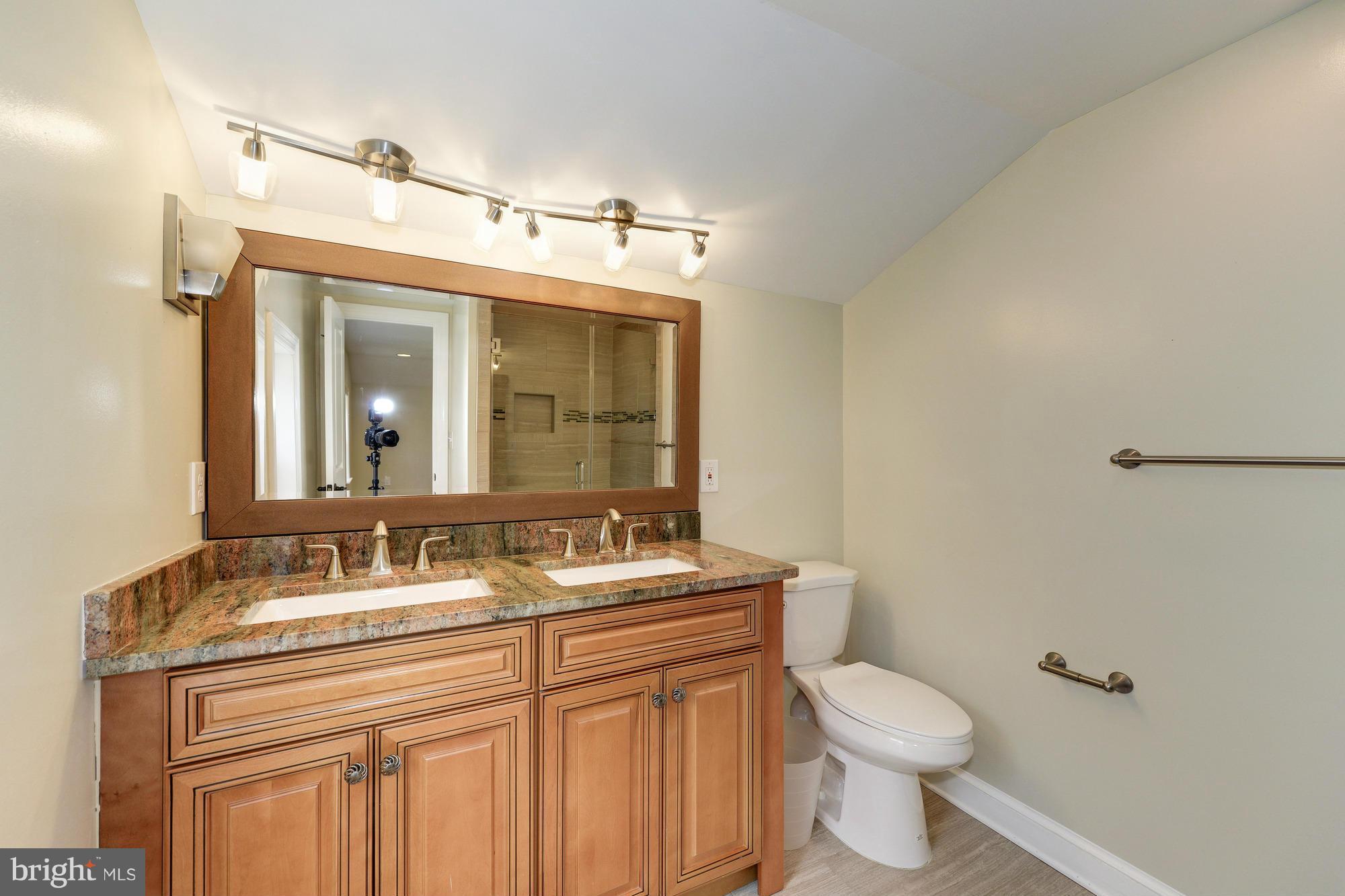 3510 Russell Road Alexandria, VA 22305 - Photo 16 of 30 a bathroom with a sink a toilet and mirror
