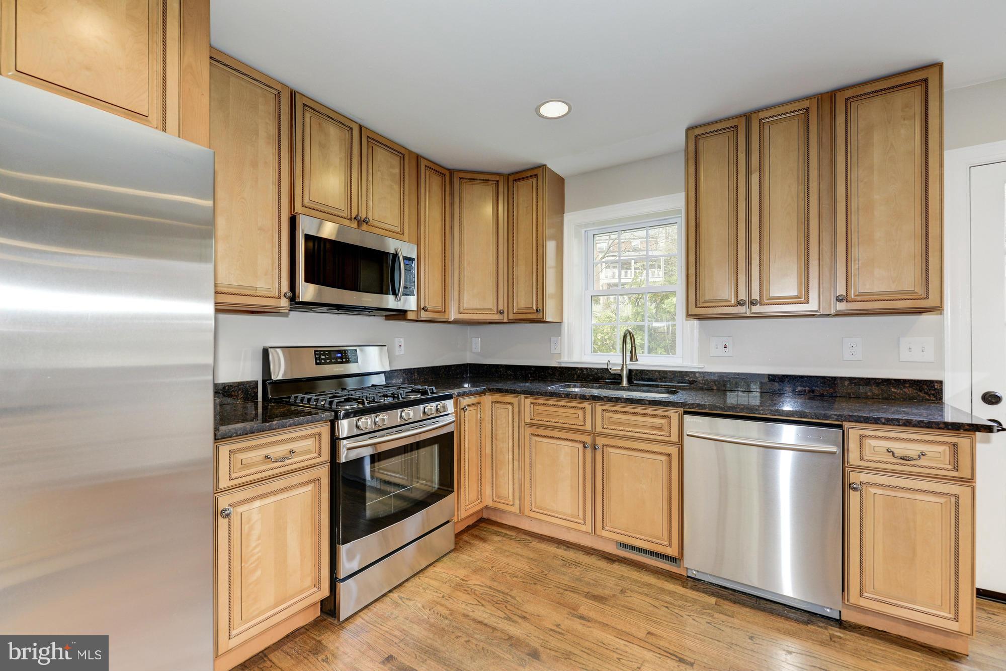 3510 Russell Road Alexandria, VA 22305 - Photo 5 of 30 a kitchen with granite countertop wooden cabinets and a stove top oven