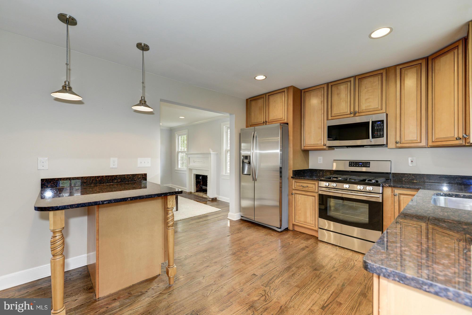 3510 Russell Road Alexandria, VA 22305 - Photo 6 of 30 a kitchen with stainless steel appliances granite countertop a sink refrigerator and microwave