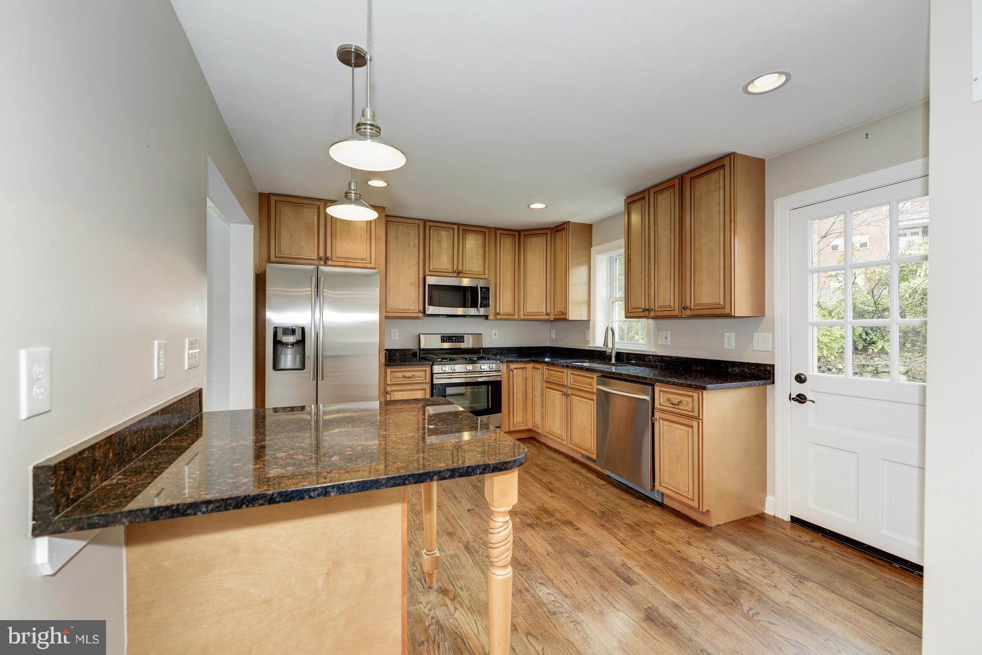 3510 Russell Road Alexandria, VA 22305 - Photo 7 of 30 a kitchen with stainless steel appliances granite countertop a sink a stove and a refrigerator