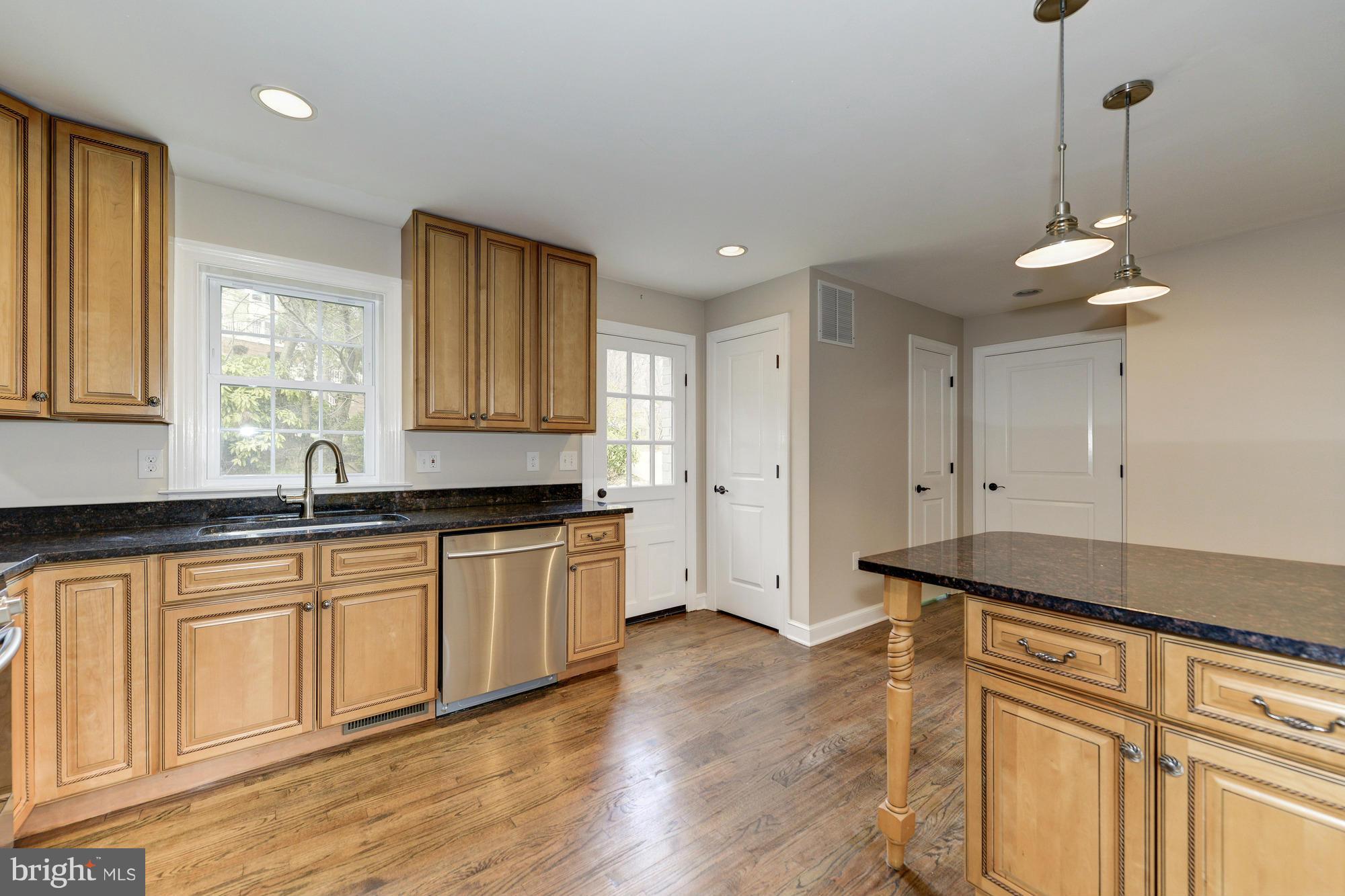 3510 Russell Road Alexandria, VA 22305 - Photo 8 of 30 a kitchen with granite countertop white cabinets and a wooden floor