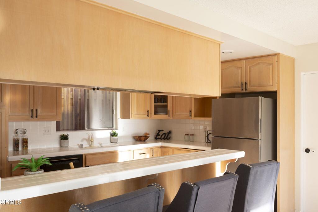 1223 El Encanto Drive Brea, CA 92821 - Photo 11 of 36 a kitchen with stainless steel appliances granite countertop a sink refrigerator and microwave