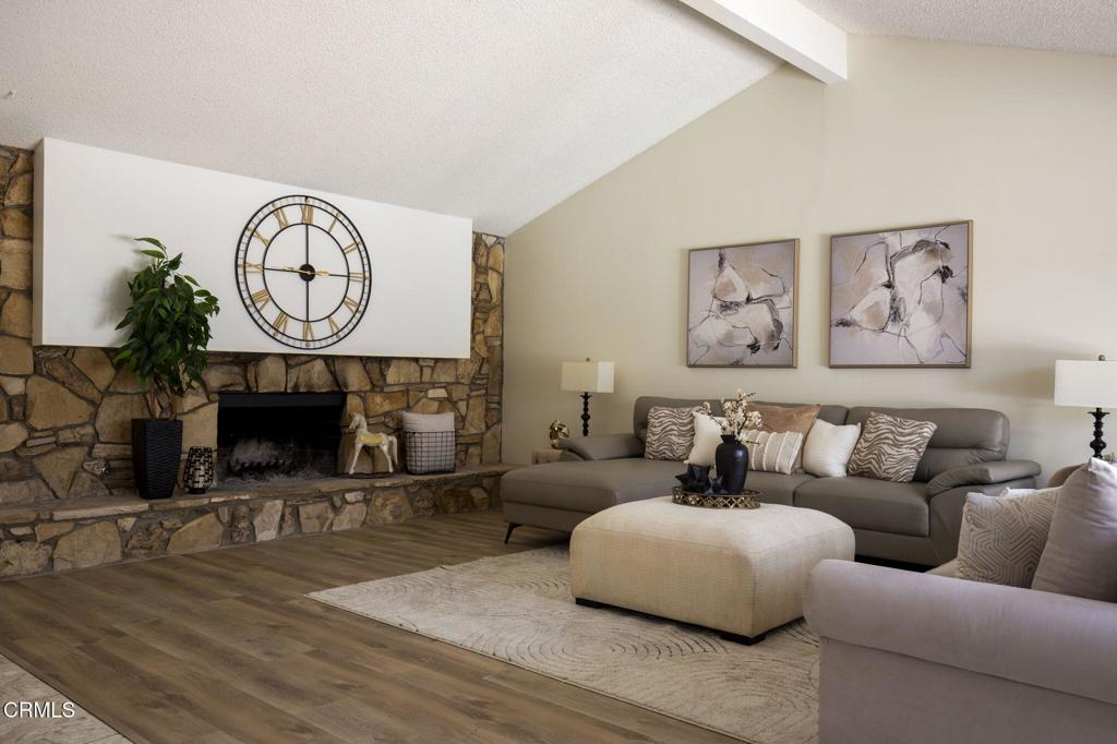 1223 El Encanto Drive Brea, CA 92821 - Photo 2 of 36 a living room with furniture a clock and a fireplace