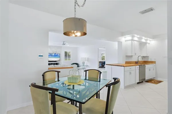 a view of a dining room with furniture and chandelier