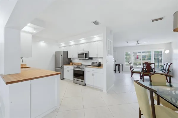a kitchen with stainless steel appliances granite countertop a refrigerator and a stove top oven