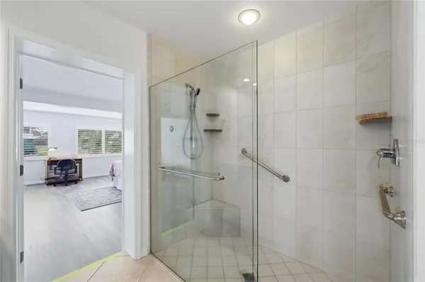 a bathroom with a sink shower and a mirror