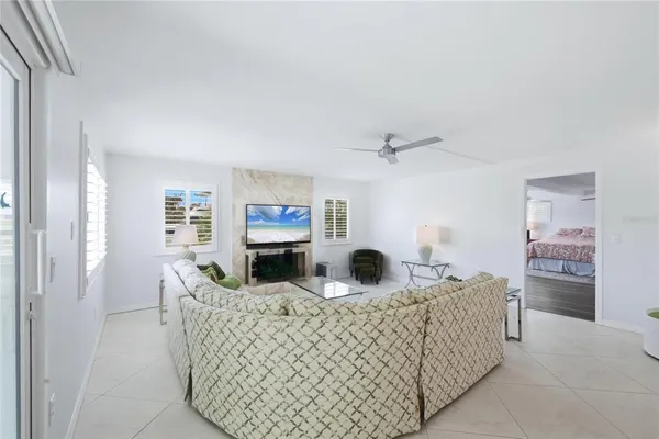 a living room with furniture a fireplace and a potted plant