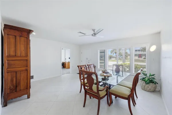 a dining room with furniture and front door