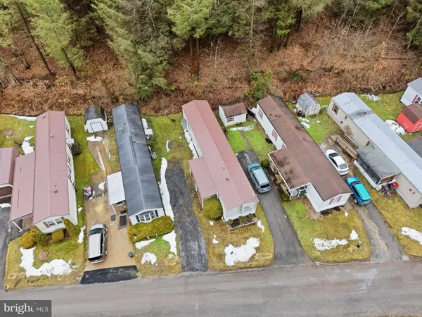 an aerial view of a house with a swimming pool and outdoor space