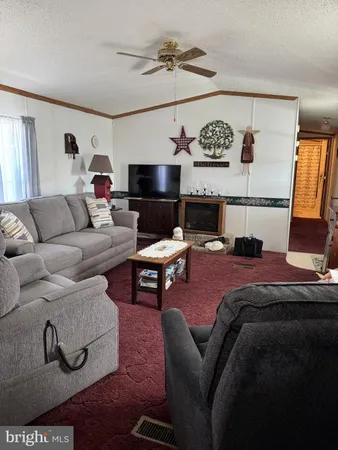 a living room with furniture and kitchen view