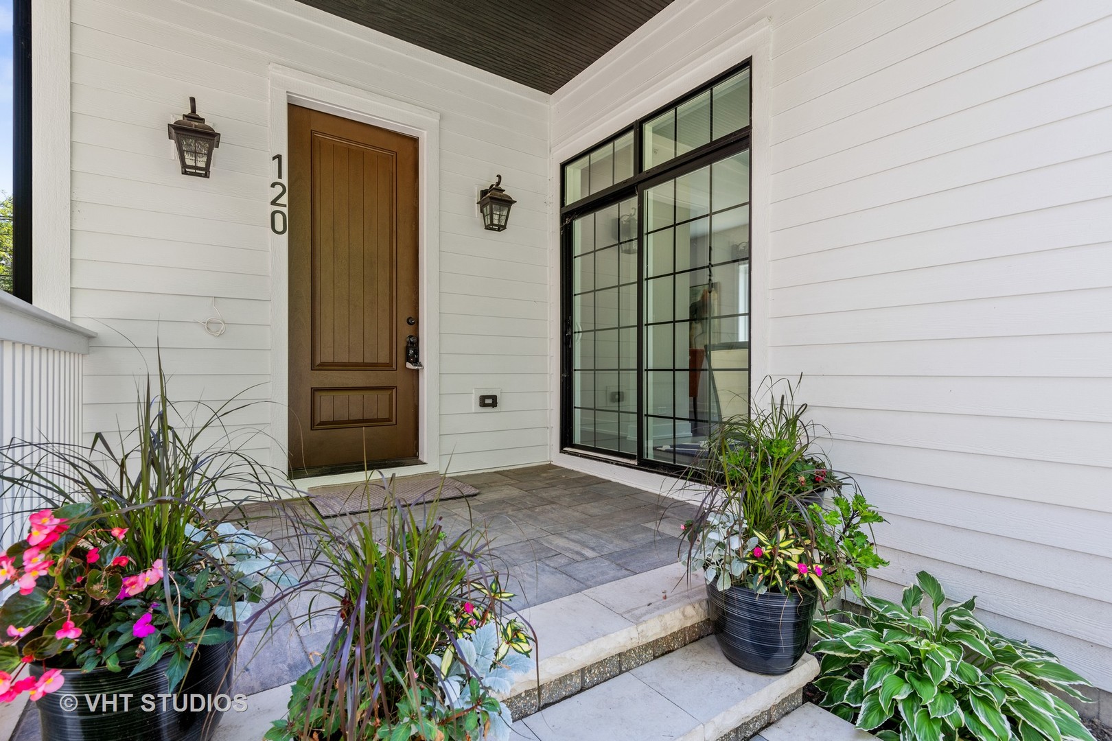 120 16th Street Wilmette, IL 60091 - Photo 2 of 34 a potted plant sitting in front of a house