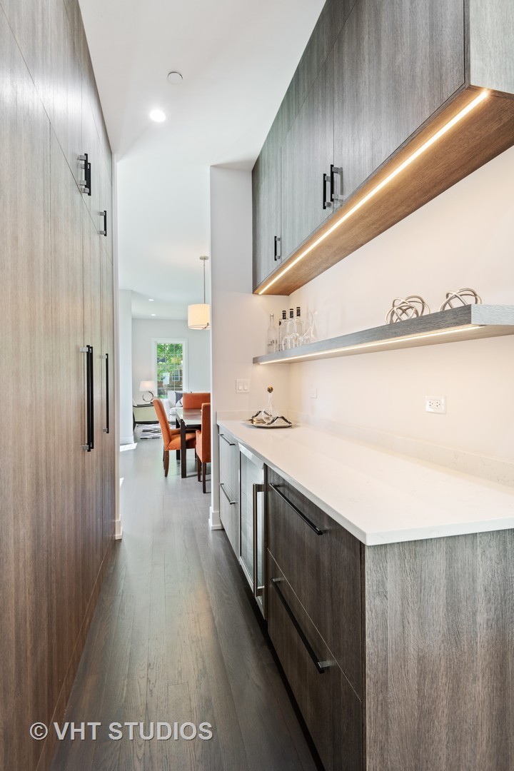 120 16th Street Wilmette, IL 60091 - Photo 6 of 34 a kitchen with stainless steel appliances a refrigerator and a wooden floor